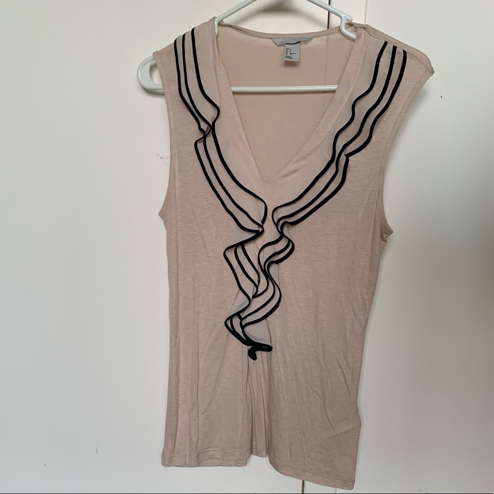 Sleeveless blush top with ruffle detail